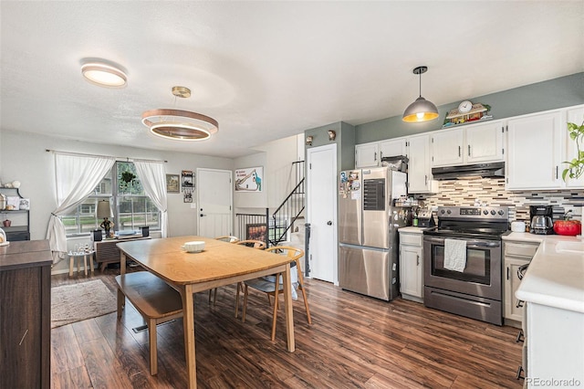 309 S 30th Ave, Brighton, CO 80601 - kitchen with appliances with stainless steel finishes, under cabinet range hood, light countertops, dark wood-style floors, and white cabinets