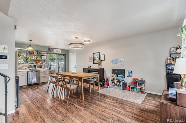 309 S 30th Ave, Brighton, CO 80601 - dining room featuring dark wood-style flooring and a textured ceiling