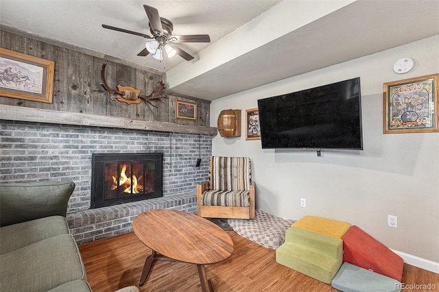 309 S 30th Ave, Brighton, CO 80601 - living area featuring a ceiling fan, wood finished floors, and a brick fireplace