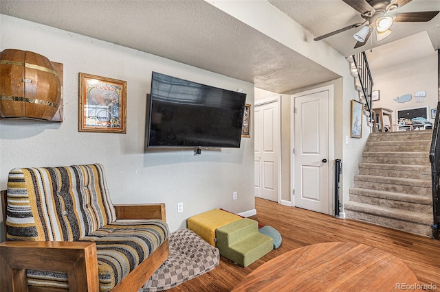 309 S 30th Ave, Brighton, CO 80601 - living area with wood finished floors, ceiling fan, stairs, and a textured ceiling