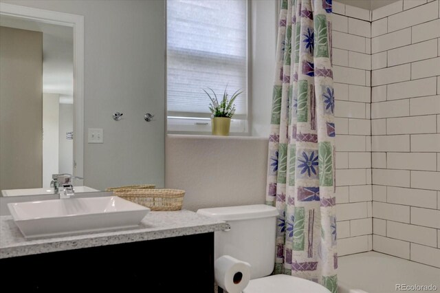 full bathroom with vanity, toilet, and shower / bath combo