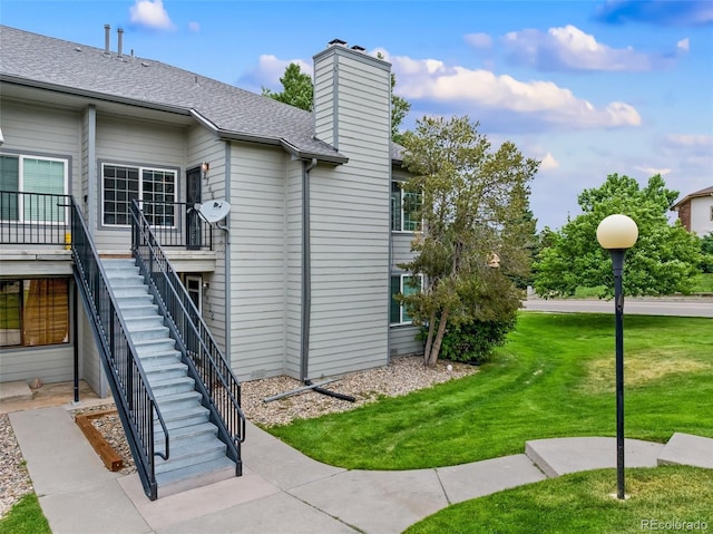 view of side of property with a lawn