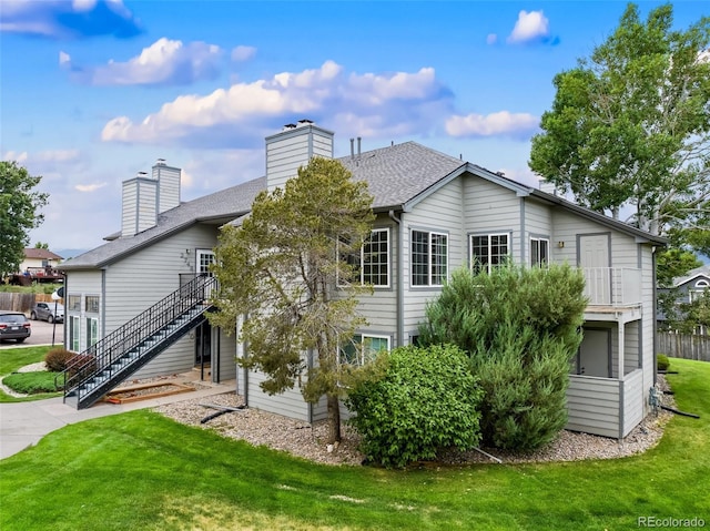 rear view of house featuring a yard