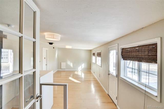 entryway featuring a textured ceiling and light wood-type flooring