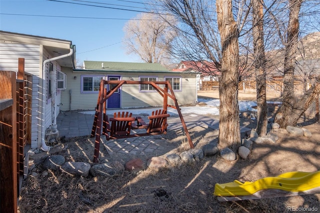 rear view of house featuring a patio area and a playground