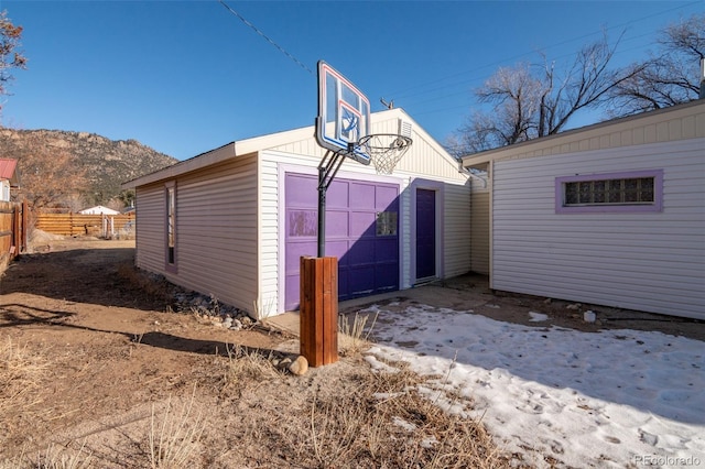 exterior space with a garage and a mountain view