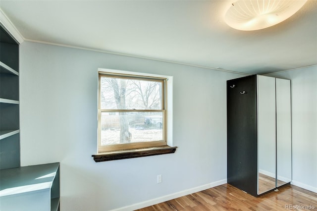 unfurnished bedroom featuring baseboards and wood finished floors