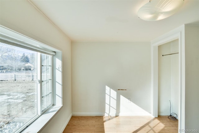 unfurnished room featuring baseboards and wood finished floors