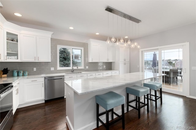 kitchen featuring a kitchen island, white cabinetry, and stainless steel appliances