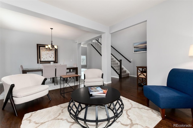 living room featuring a chandelier and dark hardwood / wood-style floors