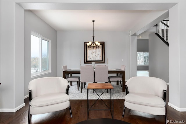 interior space featuring an inviting chandelier and dark wood-type flooring