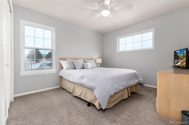 carpeted bedroom with multiple windows and ceiling fan