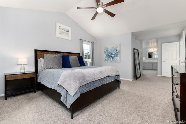 carpeted bedroom featuring ceiling fan, ensuite bathroom, and lofted ceiling