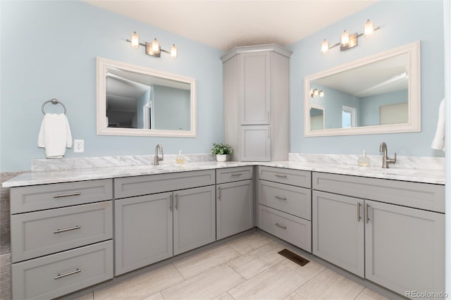 bathroom with tile patterned floors and vanity