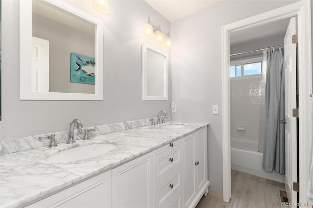 bathroom featuring vanity, shower / bath combination with curtain, and wood-type flooring