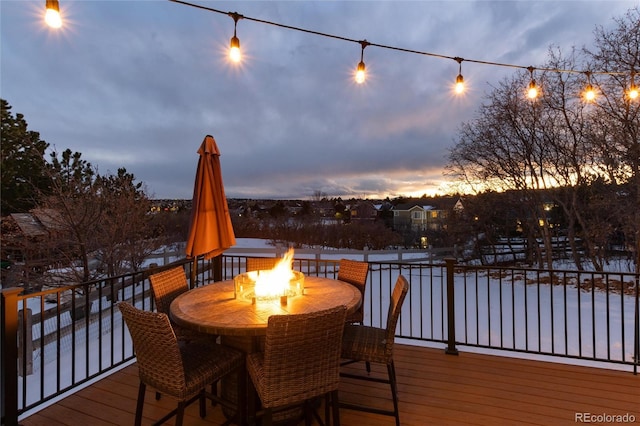 deck at dusk with a fire pit