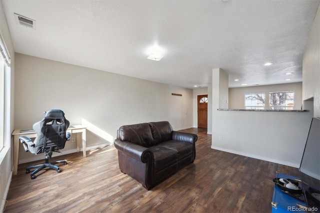 office space featuring recessed lighting, wood finished floors, visible vents, and baseboards