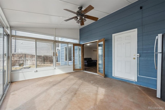 unfurnished sunroom with lofted ceiling and ceiling fan