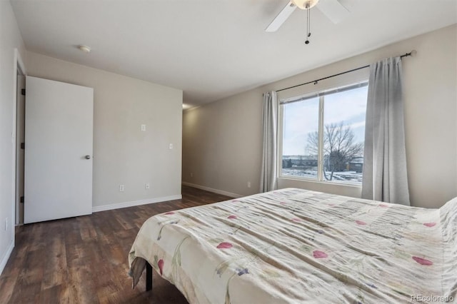 bedroom with baseboards, dark wood finished floors, and a ceiling fan