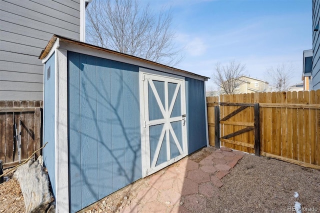 view of shed featuring fence