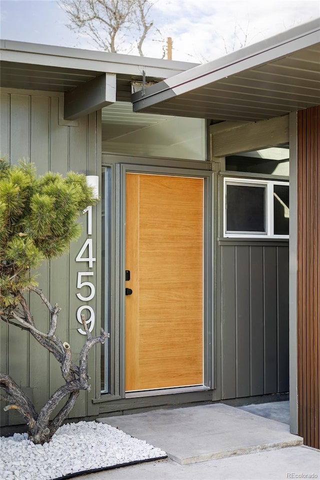 doorway to property featuring board and batten siding