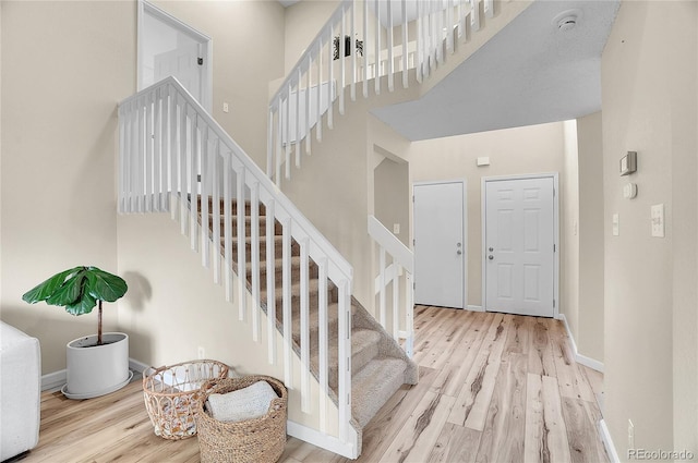 2140 W 135th Ave, Westminster, CO 80234 - stairs featuring wood finished floors, a high ceiling, and baseboards