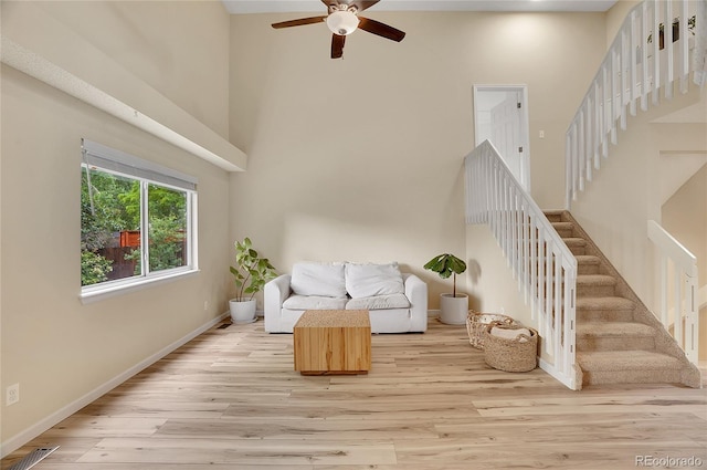 2140 W 135th Ave, Westminster, CO 80234 - living area featuring a high ceiling, ceiling fan, stairway, and light wood-style flooring
