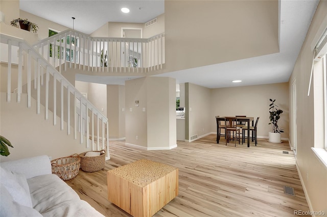 2140 W 135th Ave, Westminster, CO 80234 - living room featuring light wood-type flooring, baseboards, a towering ceiling, and recessed lighting