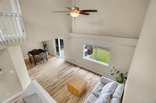2140 W 135th Ave, Westminster, CO 80234 - living area with wood finished floors, baseboards, a ceiling fan, and a towering ceiling