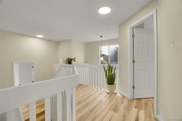 2140 W 135th Ave, Westminster, CO 80234 - corridor with an upstairs landing, light wood finished floors, recessed lighting, and baseboards