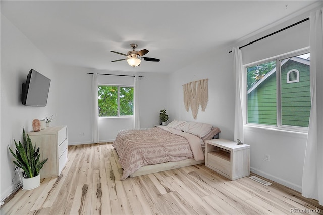 2140 W 135th Ave, Westminster, CO 80234 - bedroom with multiple windows, light wood-style floors, and baseboards