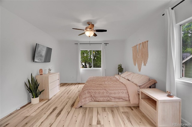 2140 W 135th Ave, Westminster, CO 80234 - bedroom featuring light wood-style flooring, multiple windows, baseboards, and a ceiling fan