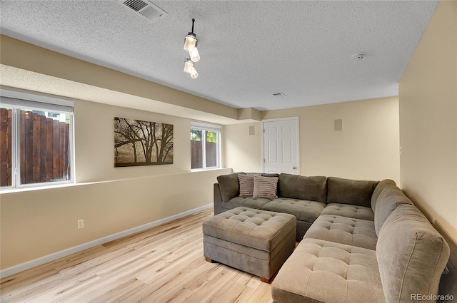 2140 W 135th Ave, Westminster, CO 80234 - living area featuring wood finished floors, baseboards, and a textured ceiling