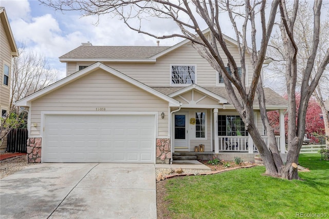 view of front facade featuring roof with shingles, a garage, a front yard, concrete driveway, and covered porch