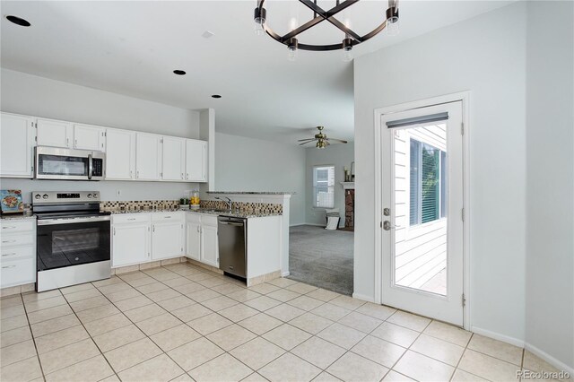 kitchen featuring a sink, white cabinetry, a peninsula, and stainless steel appliances
