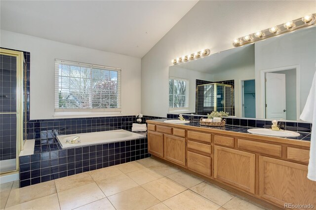 full bathroom featuring a garden tub, a sink, lofted ceiling, and a shower stall