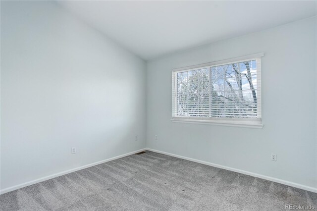 unfurnished room with carpet floors, baseboards, and visible vents
