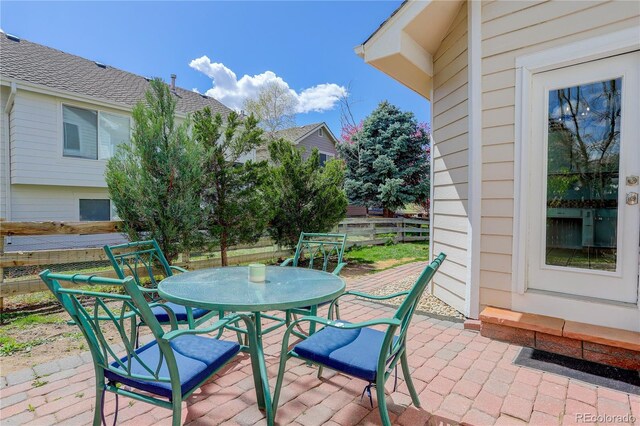 view of patio with fence and outdoor dining space