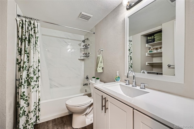 full bathroom with toilet, a textured ceiling, hardwood / wood-style flooring, shower / bath combo, and vanity