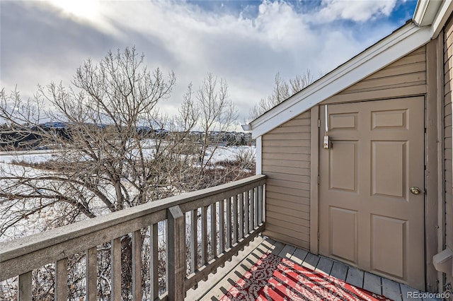 view of snow covered back of property