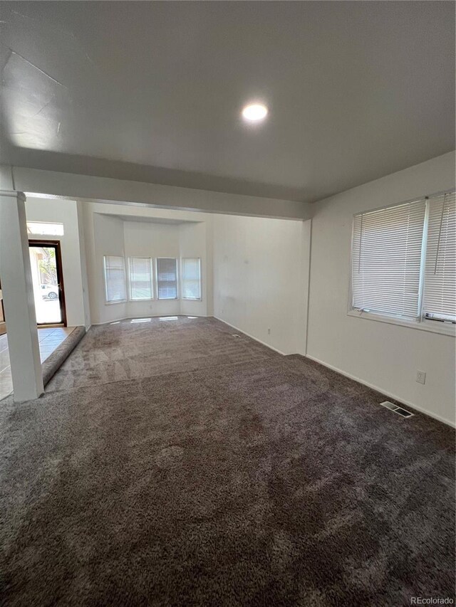 15983 E Loyola Dr, Aurora, CO 80013 - spare room featuring carpet floors and visible vents