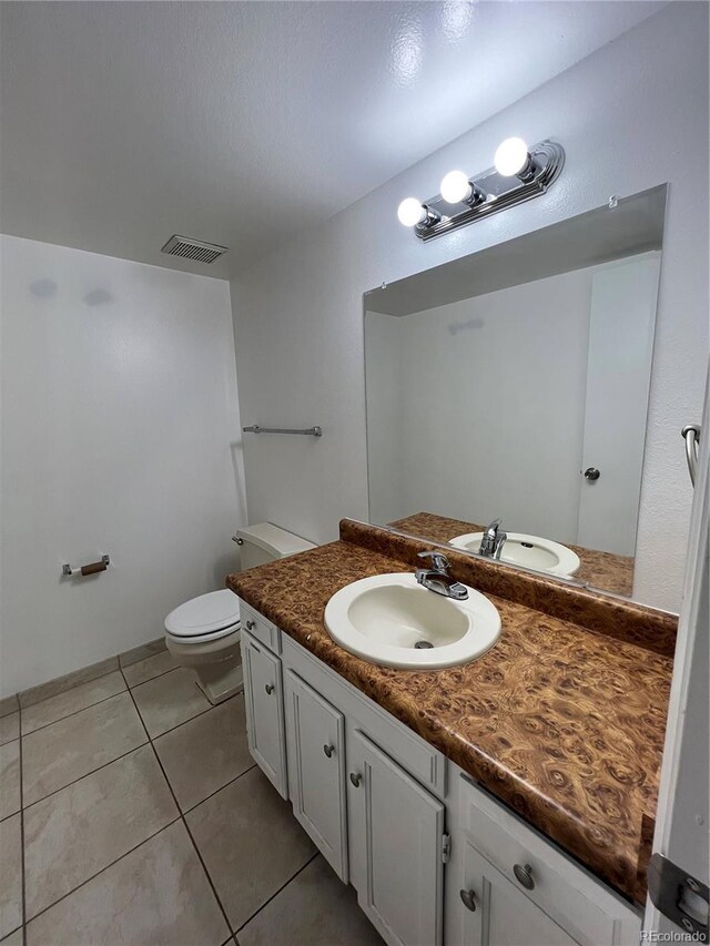 15983 E Loyola Dr, Aurora, CO 80013 - bathroom with toilet, visible vents, tile patterned flooring, and vanity