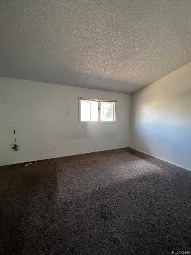 15983 E Loyola Dr, Aurora, CO 80013 - spare room featuring carpet flooring, a textured ceiling, and visible vents