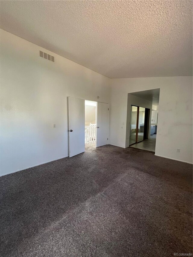 15983 E Loyola Dr, Aurora, CO 80013 - empty room featuring carpet flooring, a textured ceiling, and visible vents