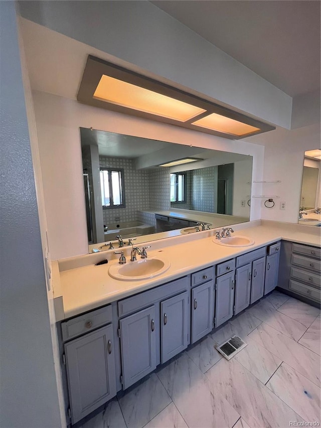 15983 E Loyola Dr, Aurora, CO 80013 - full bath featuring double vanity, visible vents, a sink, and marble finish floor