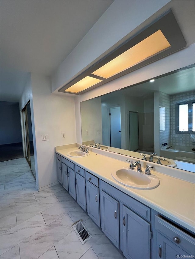 15983 E Loyola Dr, Aurora, CO 80013 - full bath with a sink, double vanity, and marble finish floor