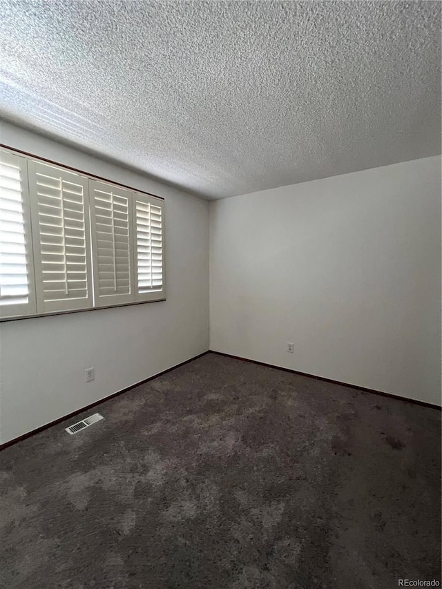 15983 E Loyola Dr, Aurora, CO 80013 - carpeted spare room with a textured ceiling, visible vents, a healthy amount of sunlight, and baseboards