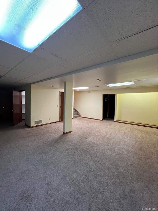 15983 E Loyola Dr, Aurora, CO 80013 - finished below grade area with visible vents, baseboards, stairway, a paneled ceiling, and carpet