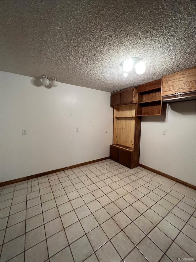 15983 E Loyola Dr, Aurora, CO 80013 - spare room with baseboards and a textured ceiling