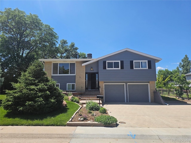 7270 S Cherry Dr, Centennial, CO 80122 - view of front facade with an attached garage, driveway, and brick siding